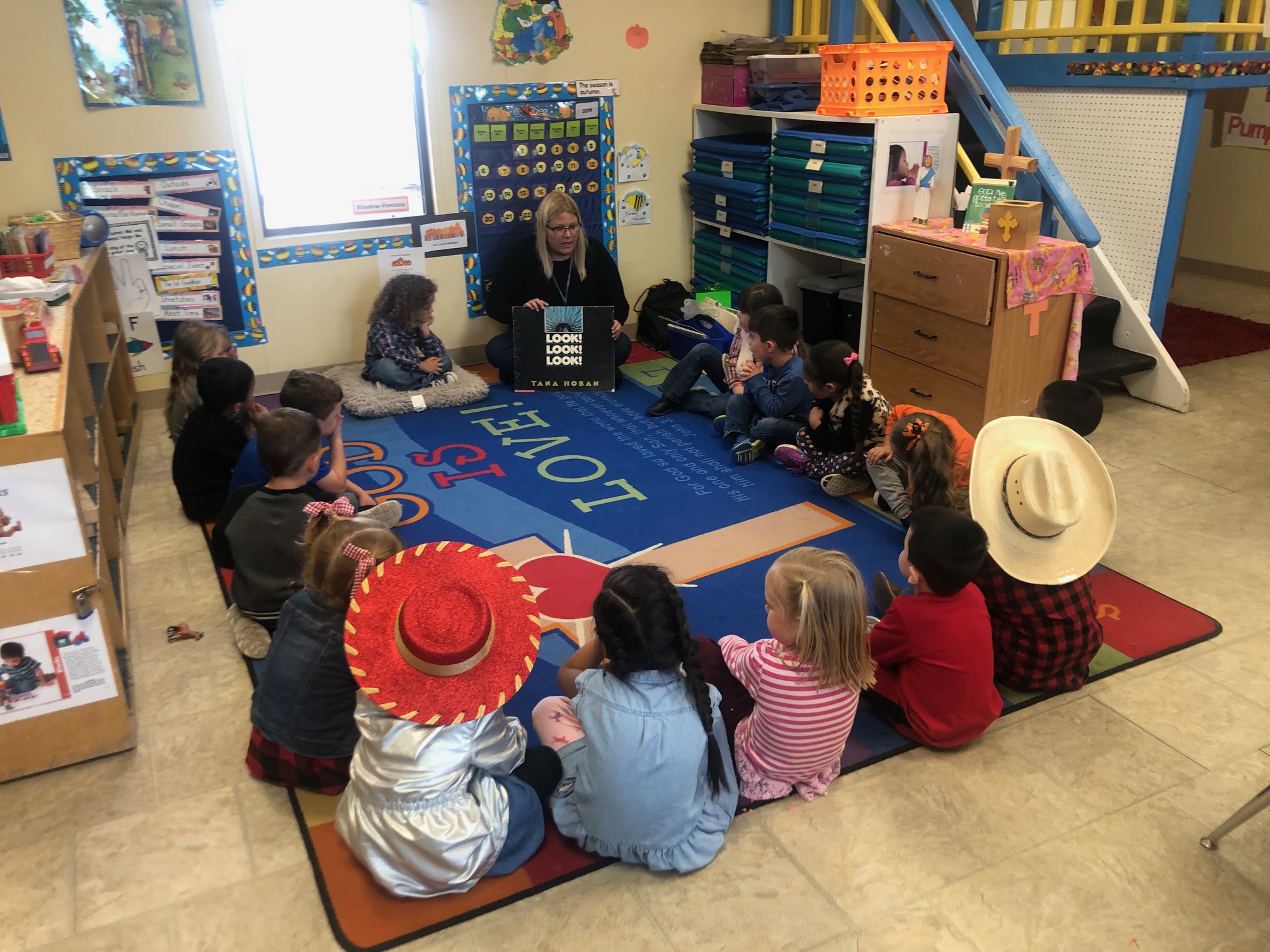 Kids with old western hats sitting in a circle